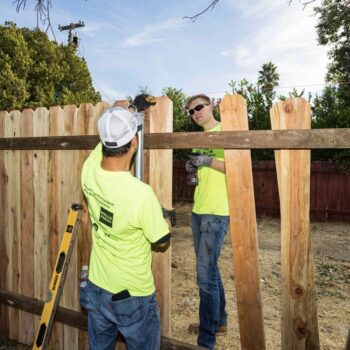 Habitat volunteers building a fence